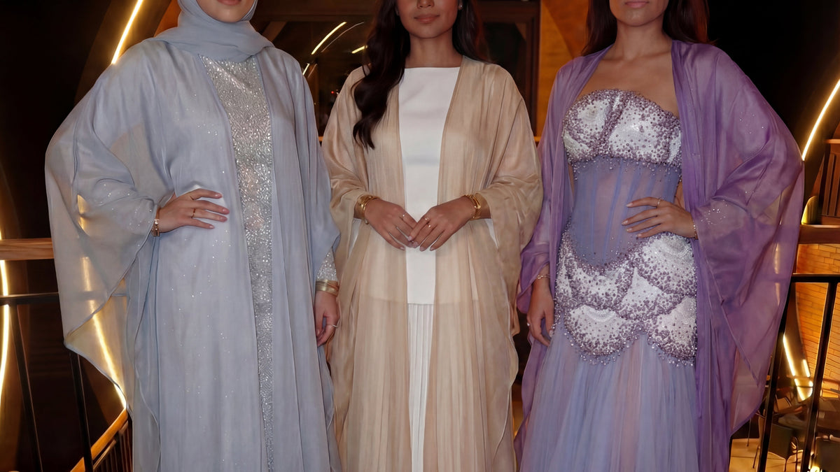 Three girls wearing beautiful zara abayas from sharafiya in blue, beige and purple